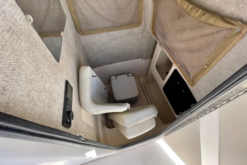 Slide: The Image of 2004 Grady-White Advance 257 boat interior with seating and storage. - 22