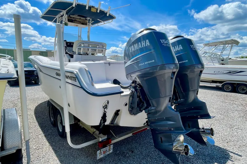 Slide: The Image of 2004 Grady-White Advance 257 boat with twin Yamaha 150 engines, parked outdoors. - 6