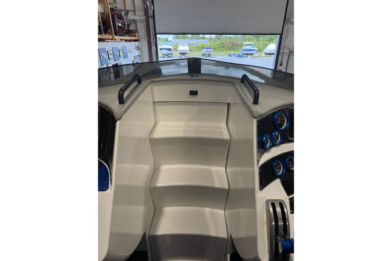 Slide: The Image of Interior view of 2016 Hustler 39 boat cockpit with control panel and steps. - 11