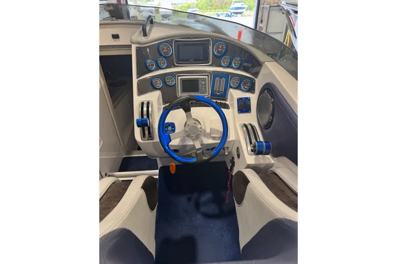 Slide: The Image of Cockpit of 2016 Hustler 39 boat with blue accents and modern controls. - 12