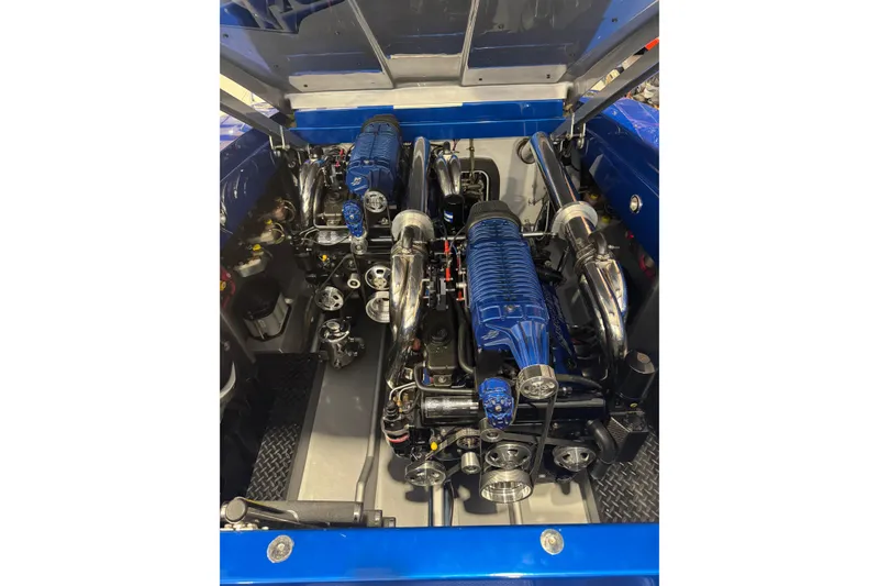 Slide: The Image of Engine compartment of a 2016 Hustler 39 with dual blue superchargers. - 14