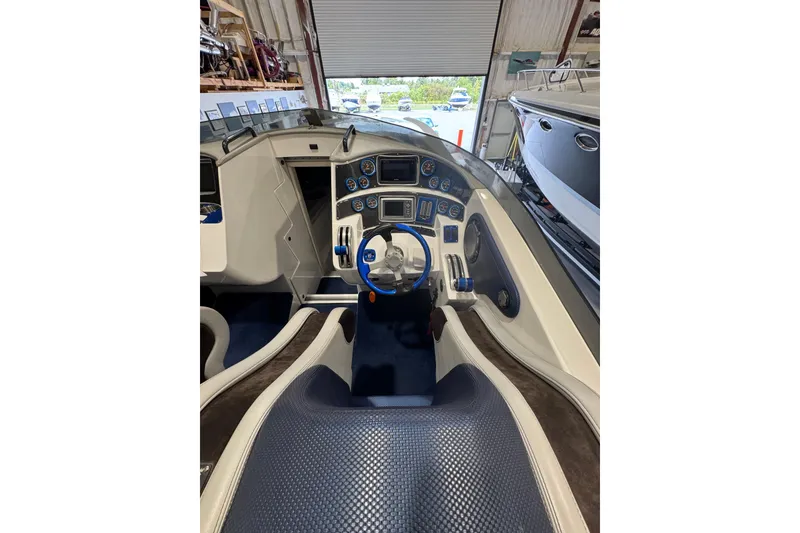 Slide: The Image of 2016 Hustler 39 boat cockpit with modern controls and steering wheel. - 15