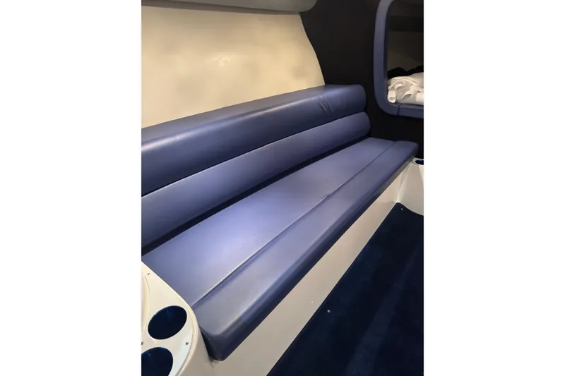 Slide: The Image of 2016 Hustler 39 interior with blue leather seating and cup holders. - 17