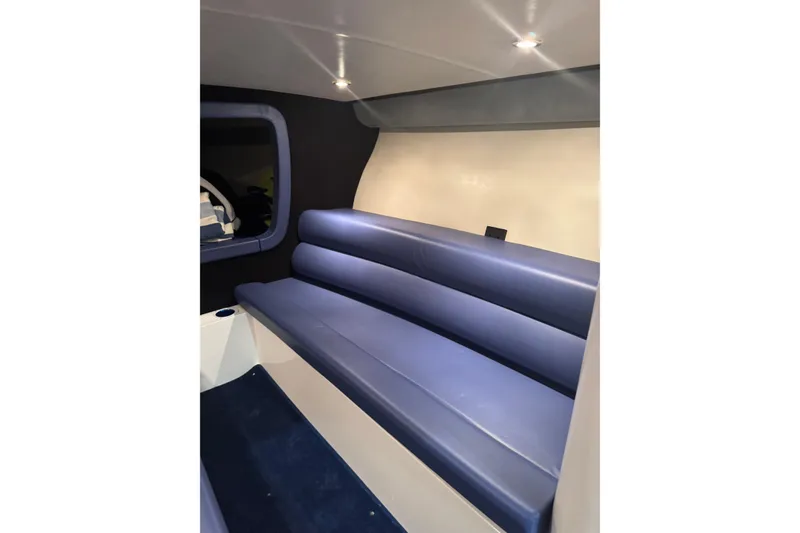 Slide: The Image of Interior of 2016 Hustler 39 boat with blue seating and modern lighting. - 18