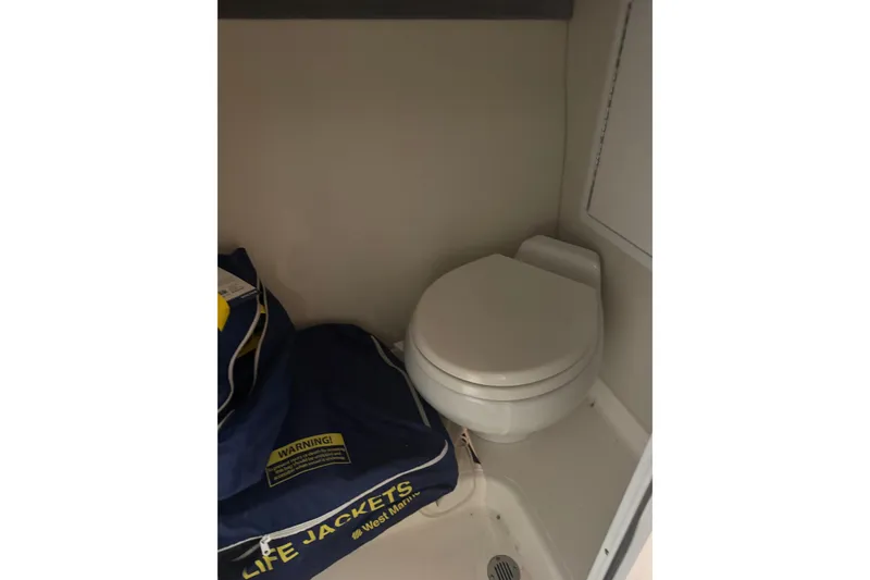 Slide: The Image of Compact boat bathroom with toilet and life jackets, Hustler 39, 2016 model. - 19