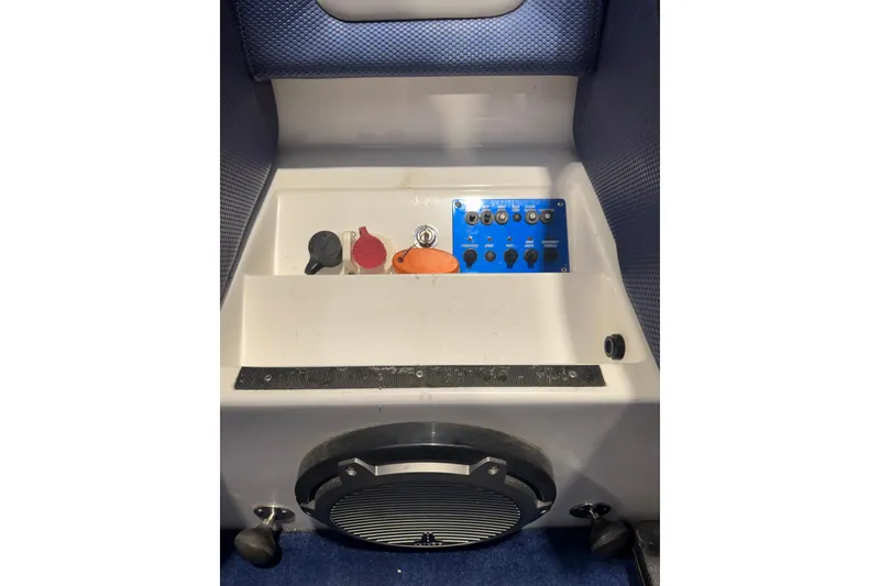 Slide: The Image of Control panel of a 2016 Hustler 39 boat with switches and speaker. - 21