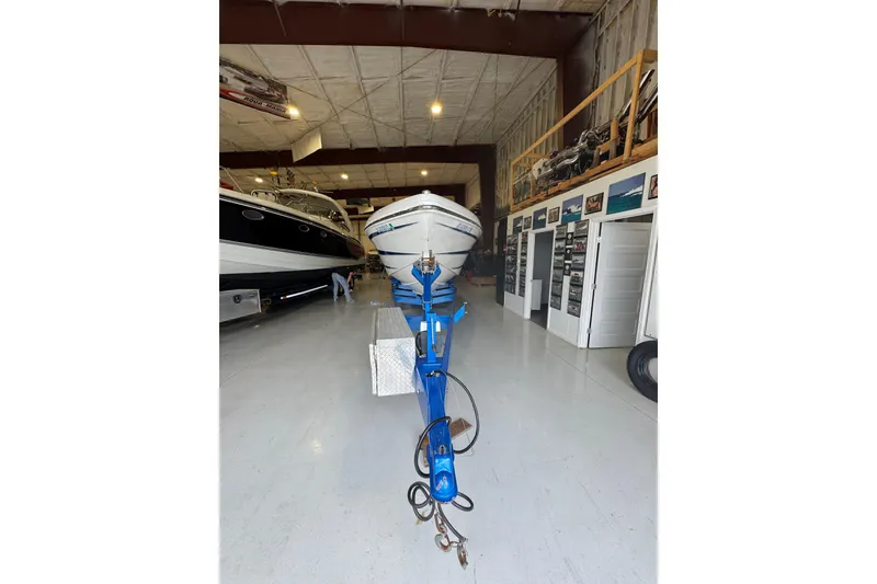 Slide: The Image of 2016 Hustler 39 boat on trailer in indoor storage facility. - 7