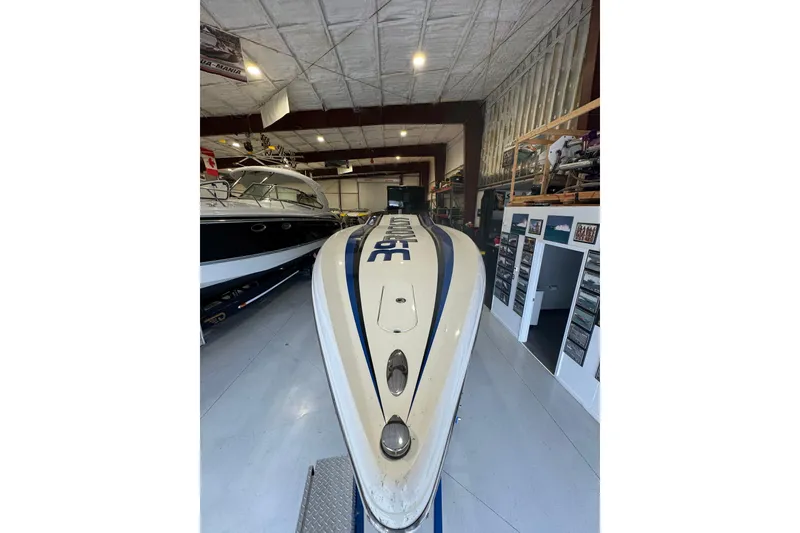 Slide: The Image of 2016 Hustler 39 boat in a spacious indoor storage facility. - 8