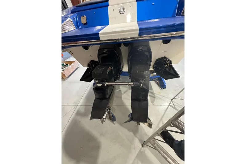 Slide: The Image of Rear view of a 2016 Hustler 39 boat with dual outboard motors. - 9