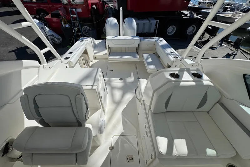 Slide: The Image of 2022 Pursuit DC 266 Dual Console boat interior with seating and cup holders. - 12