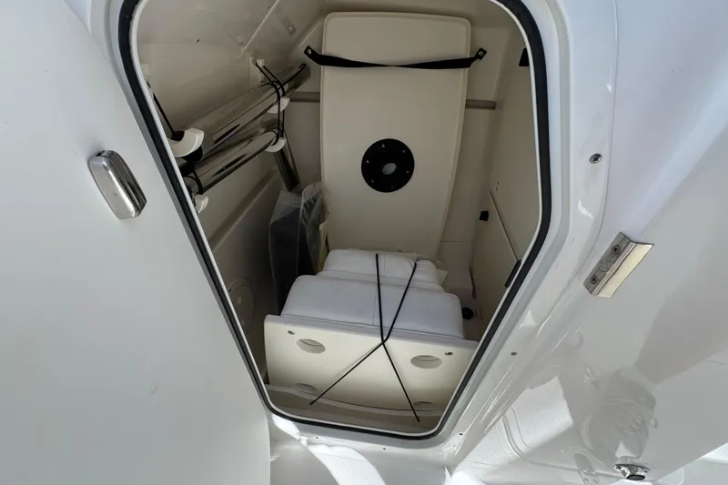 Slide: The Image of 2022 Pursuit DC 266 Dual Console storage compartment interior view. - 15