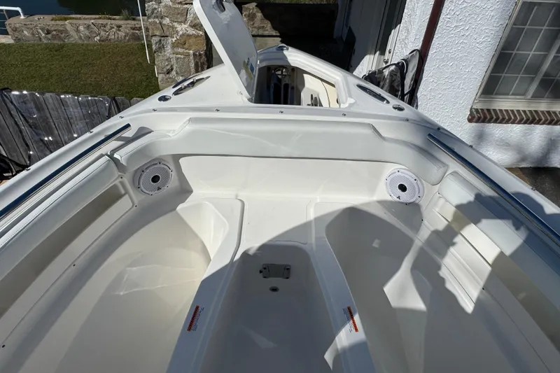 Slide: The Image of 2022 Pursuit DC 266 Dual Console boat interior with open storage compartment. - 7