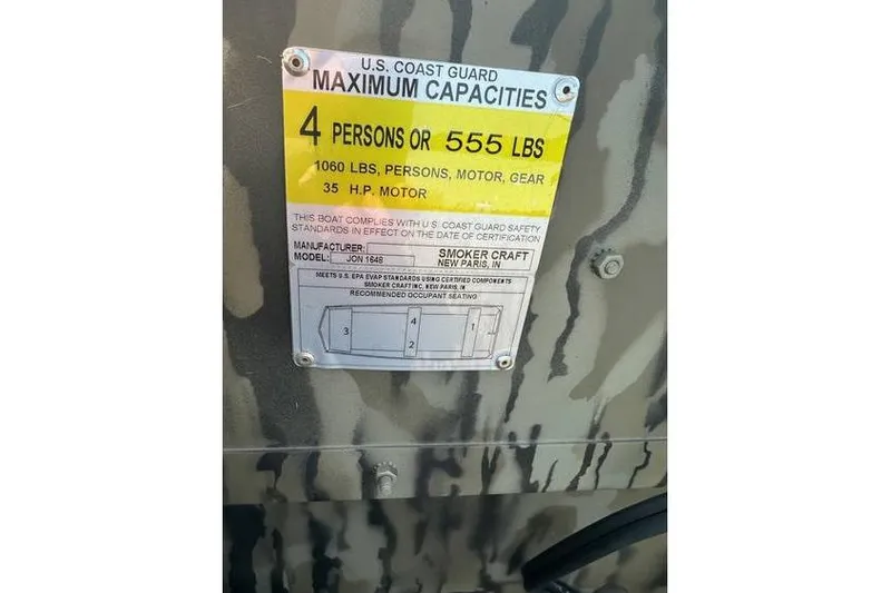 Slide: The Image of 2025 Smoker Craft 1648 Jon boat capacity label, 4 persons or 555 lbs, 35 HP motor. - 9