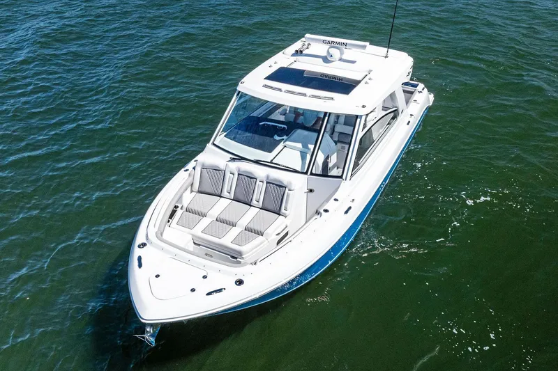 Slide: The Image of Manufacturer Provided Image: 2025 Everglades 367 CX boat cruising on open water, aerial view. - 2