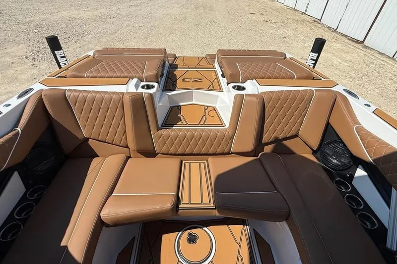 Slide: The Image of Luxurious interior of 2026 Tigé Z3 boat with brown quilted seating and cup holders. - 11