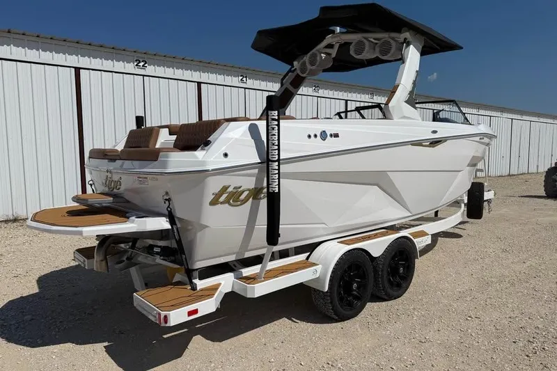 Slide: The Image of 2026 Tigé Z3 boat on trailer, white exterior, parked outdoors. - 2
