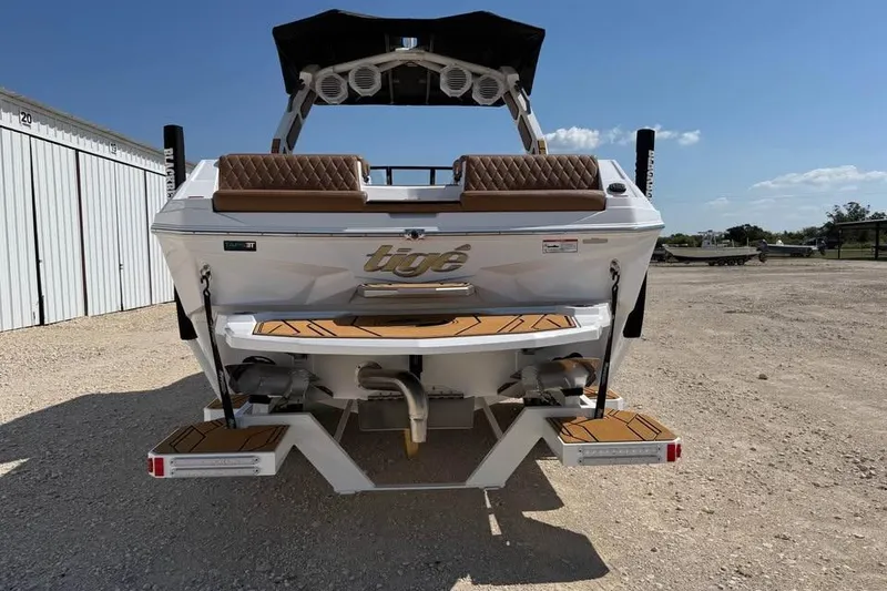 Slide: The Image of 2026 Tigé Z3 boat rear view with teak swim platform and cushioned seating. - 4
