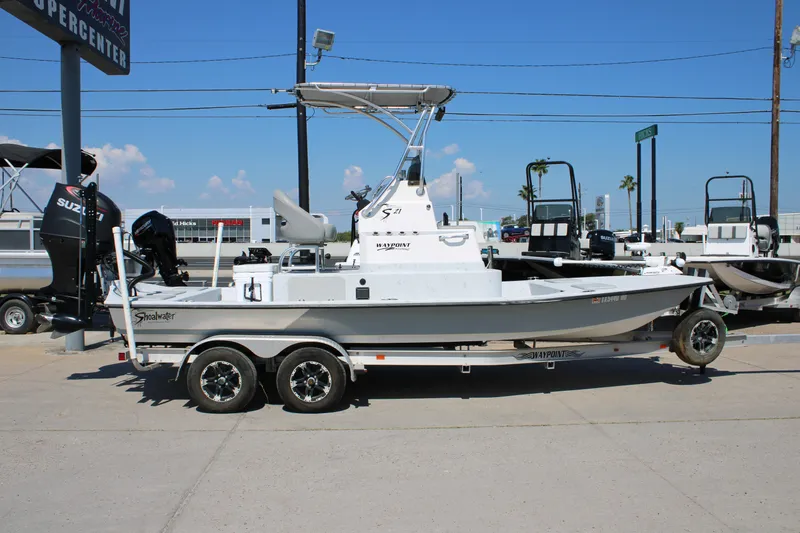 Slide: The Image of 2020 Shoalwater 21 Catamaran boat on trailer, displayed outdoors under clear blue sky. - 11