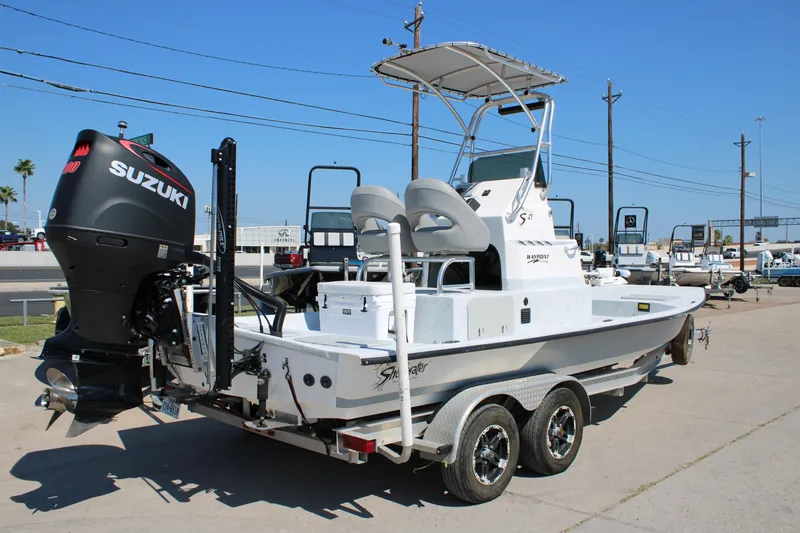 Slide: The Image of 2020 Shoalwater 21 Catamaran with Suzuki engine on trailer, parked outdoors. - 12
