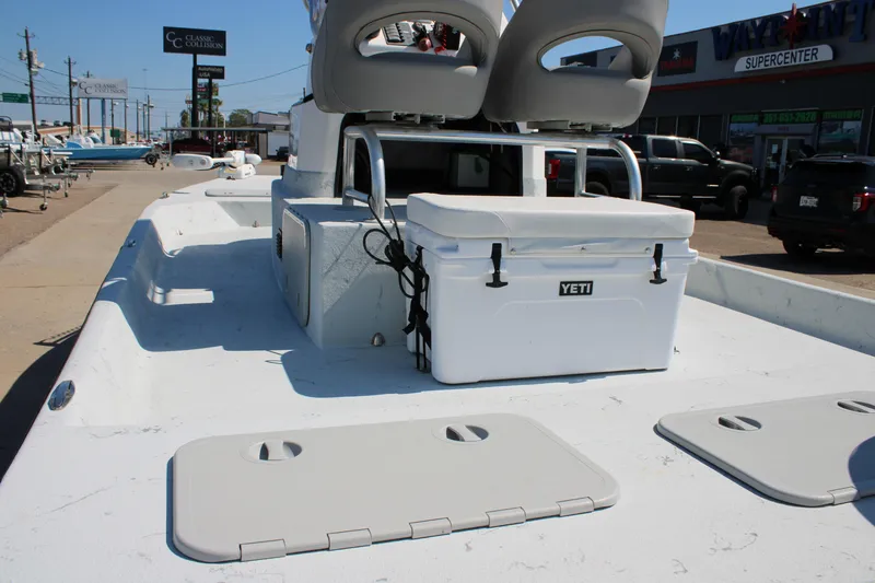 Slide: The Image of 2020 Shoalwater 21 Catamaran with Yeti cooler on deck, parked near dealership. - 15