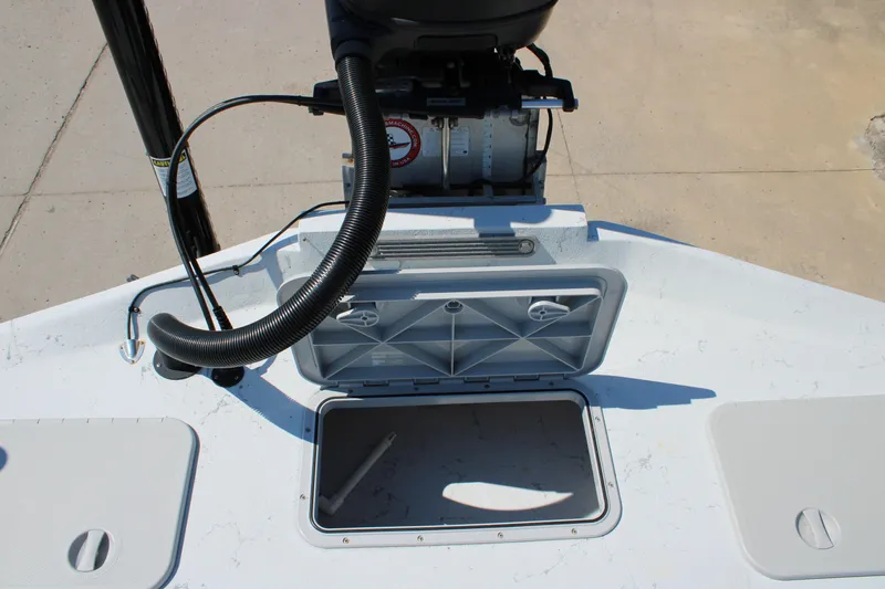 Slide: The Image of 2020 Shoalwater 21 Catamaran boat with open storage compartment and motor. - 4