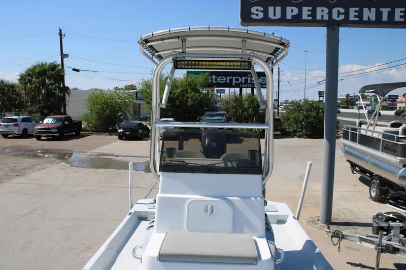 Slide: The Image of 2020 Shoalwater 21 Catamaran boat with T-top, parked at a dealership. - 6