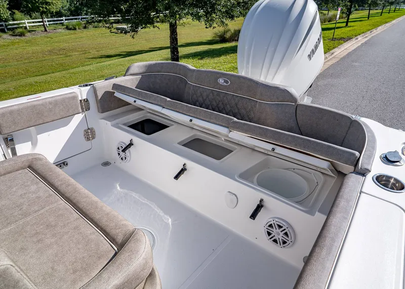 Slide: The Image of 2026 Sea Hunt Ultra 245 SE boat interior with seating and storage compartments. - 10