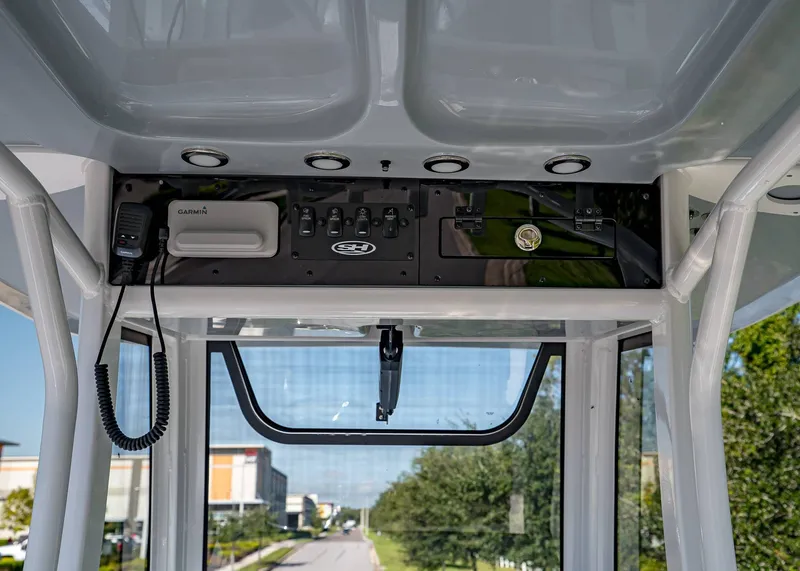 Slide: The Image of 2026 Sea Hunt Ultra 245 SE boat console with Garmin electronics and storage compartment. - 13