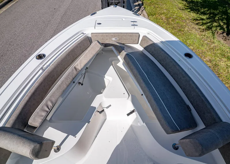 Slide: The Image of 2026 Sea Hunt Ultra 245 SE boat interior with cushioned seating and storage compartments. - 23