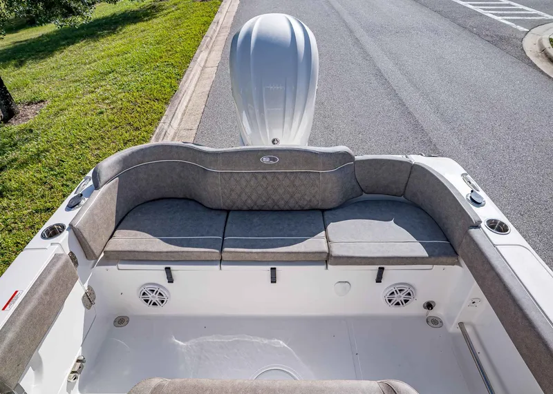 Slide: The Image of 2026 Sea Hunt Ultra 245 SE boat interior with cushioned seating and speakers. - 5