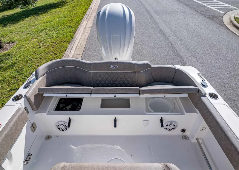 Slide: The Image of 2026 Sea Hunt Ultra 245 SE boat interior with cushioned seating and storage compartments. - 9