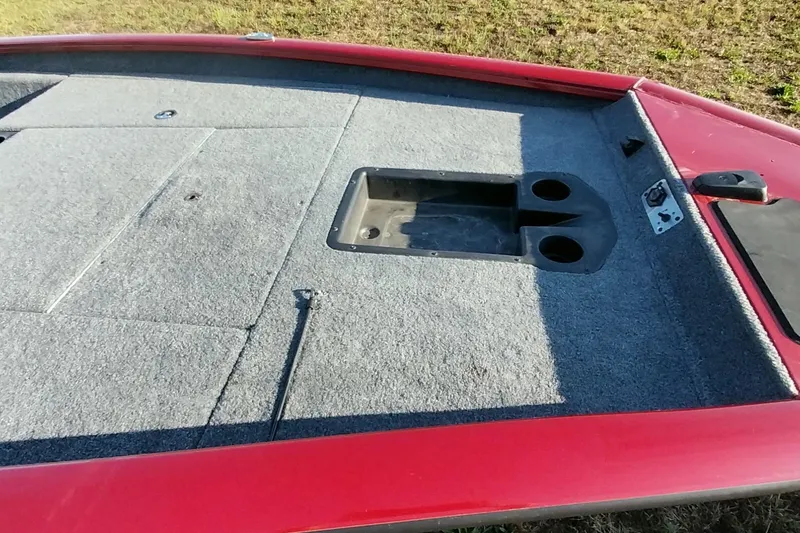 Slide: The Image of 2024 Tracker Pro Team 175 TXW boat deck with red trim and storage compartments. - 10