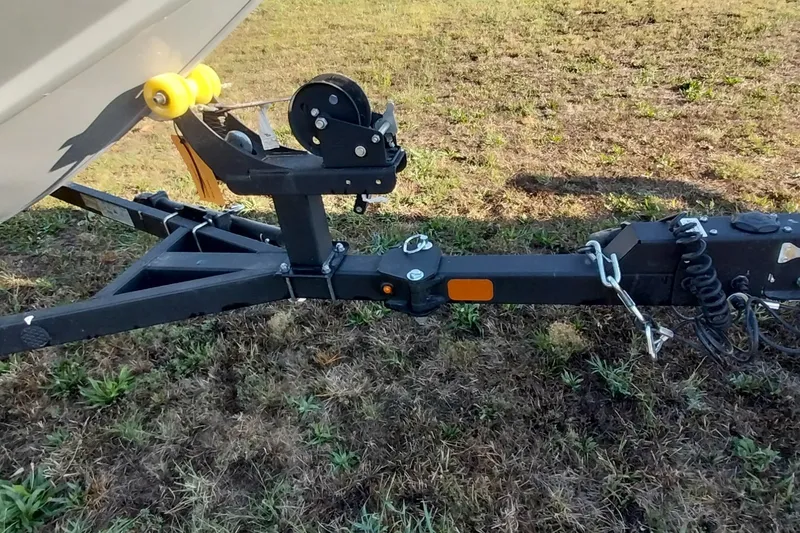 Slide: The Image of Trailer hitch of 2024 Tracker Pro Team 175 TXW on grassy ground. - 11