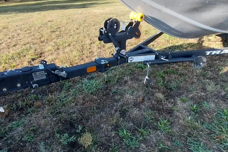 Slide: The Image of Trailer hitch of 2024 Tracker Pro Team 175 TXW boat on grassy field. - 14