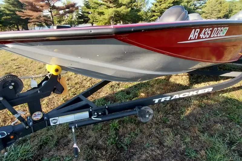 Slide: The Image of 2024 Tracker Pro Team 175 TXW boat on trailer, parked on grass. - 15