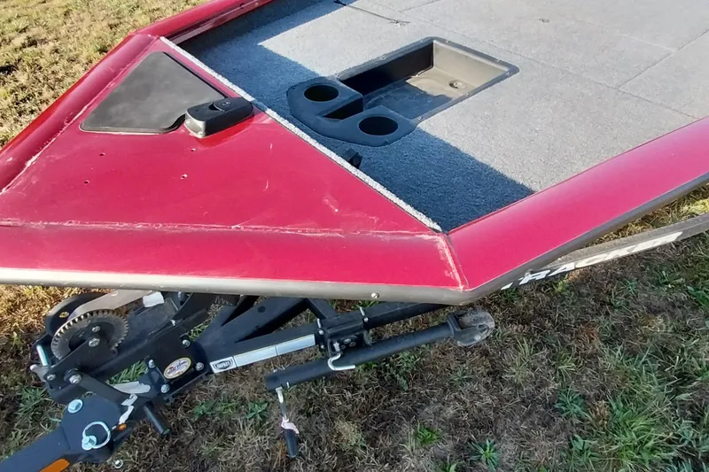 Slide: The Image of 2024 Tracker Pro Team 175 TXW boat deck with red finish and storage compartments. - 16