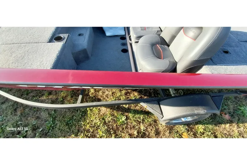 Slide: The Image of 2024 Tracker Pro Team 175 TXW boat interior with red exterior and cushioned seats. - 21