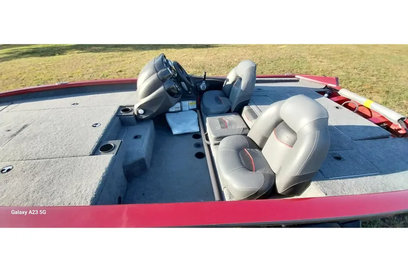 Slide: The Image of 2024 Tracker Pro Team 175 TXW boat interior with gray seating and steering console. - 22