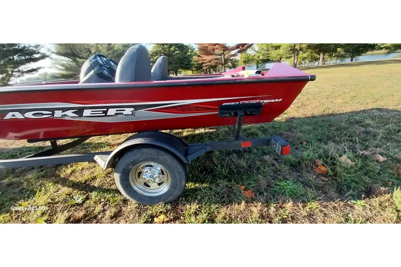 Slide: The Image of 2024 Tracker Pro Team 175 TXW boat on trailer, parked on grassy area. - 25