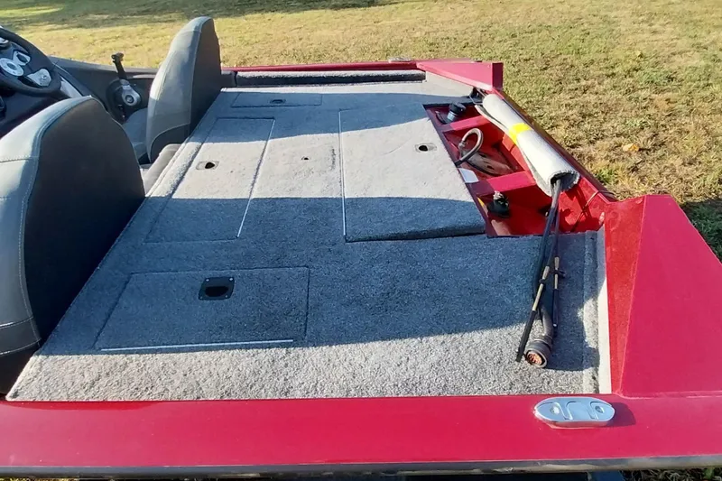 Slide: The Image of 2024 Tracker Pro Team 175 TXW boat interior with carpeted deck and storage compartments. - 27