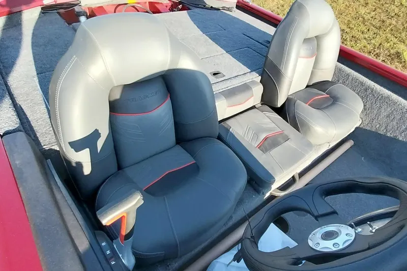 Slide: The Image of 2024 Tracker Pro Team 175 TXW boat interior with gray seats and steering wheel. - 3