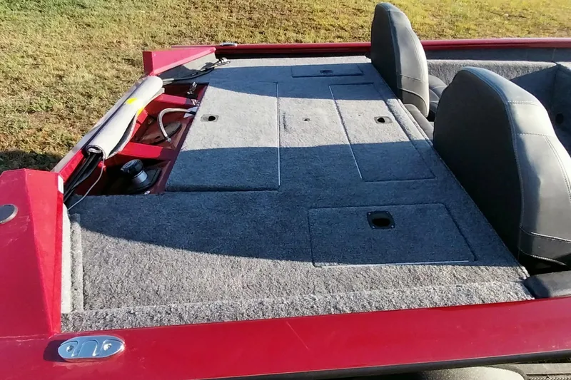 Slide: The Image of 2024 Tracker Pro Team 175 TXW boat interior with gray carpet and seating. - 34