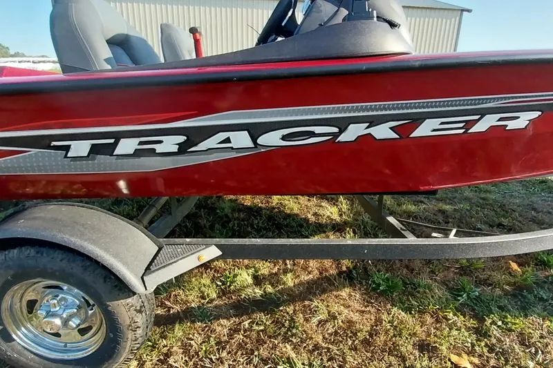 Slide: The Image of 2024 Tracker Pro Team 175 TXW boat, red exterior, on trailer, side view. - 35