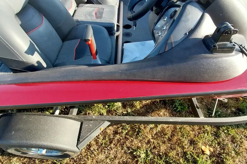 Slide: The Image of 2024 Tracker Pro Team 175 TXW boat interior with red accents and seating. - 36