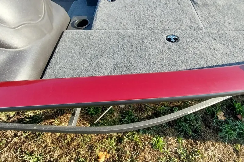 Slide: The Image of 2024 Tracker Pro Team 175 TXW boat deck with red trim and gray carpet. - 5