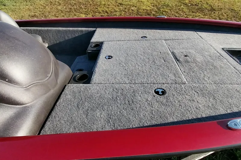 Slide: The Image of 2024 Tracker Pro Team 175 TXW boat deck with gray carpet and red trim. - 6