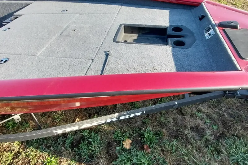 Slide: The Image of 2024 Tracker Pro Team 175 TXW boat deck with red trim and storage compartments. - 9