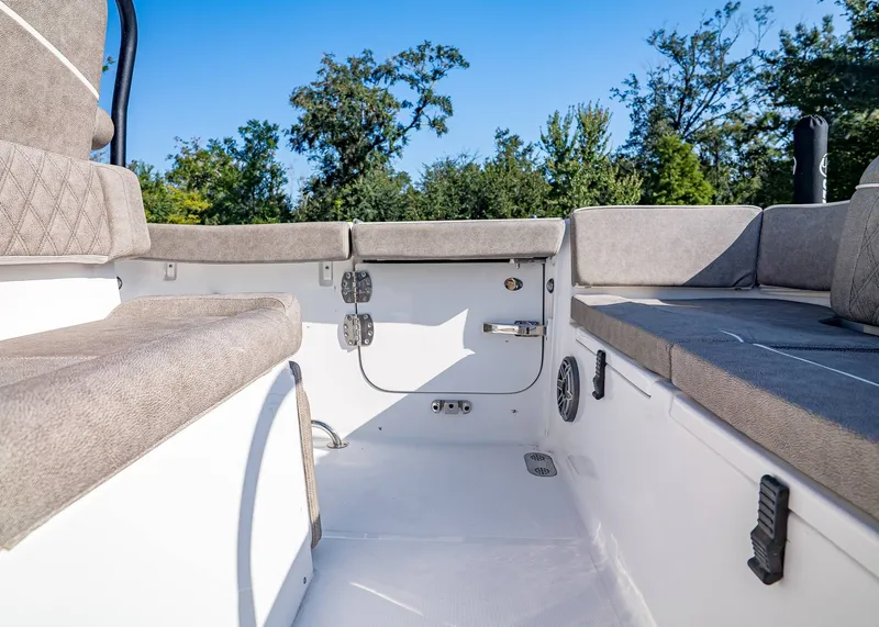 Slide: The Image of 2026 Sea Hunt Ultra 255 SE boat interior with cushioned seating and clear blue sky. - 11