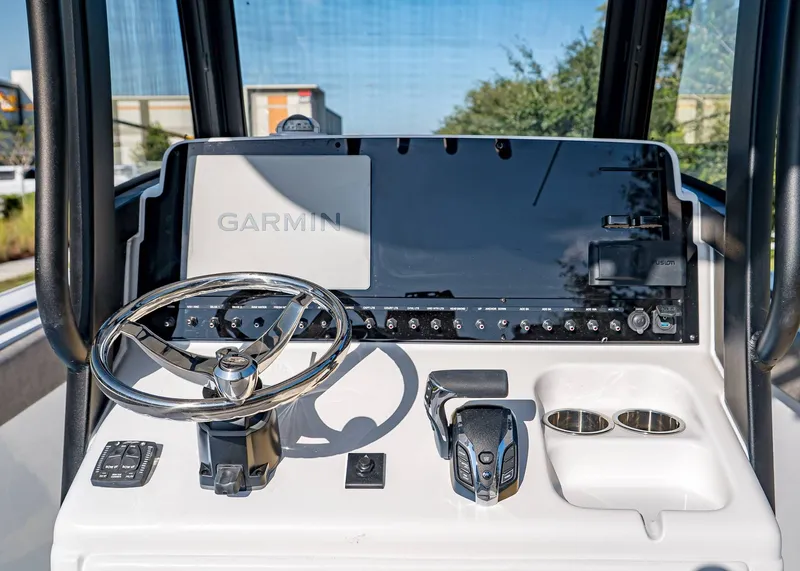 Slide: The Image of 2026 Sea Hunt Ultra 255 SE boat dashboard with Garmin display and steering wheel. - 18