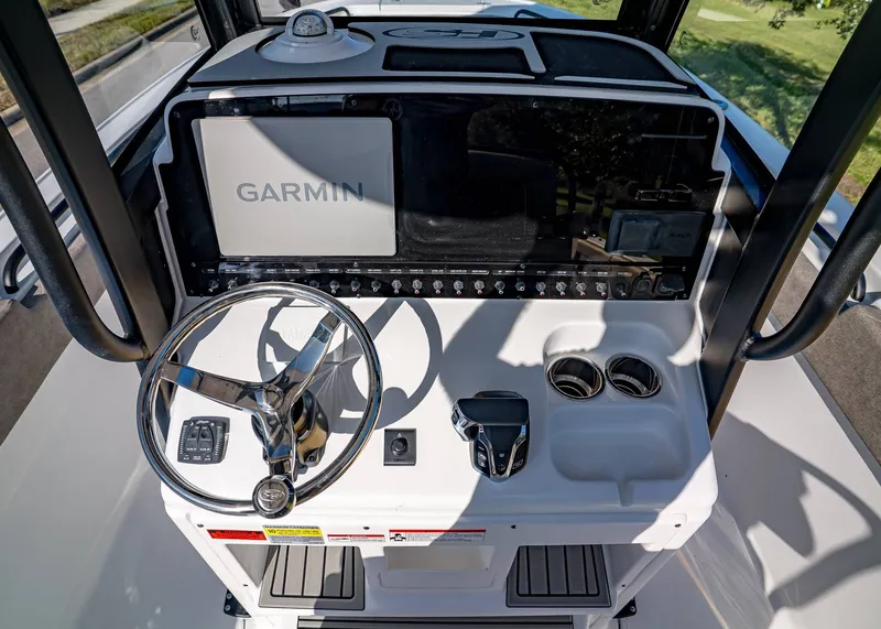 Slide: The Image of 2026 Sea Hunt Ultra 255 SE boat dashboard with Garmin navigation system and steering wheel. - 20